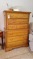 Full front view of oak-finish dresser showing six drawers and brass handles