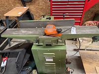 Full view of jointer on stand showing table, fence, motor housing and overall condition