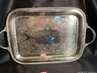 Full view of rectangular silverplate tray showing engraved scrollwork and handles.