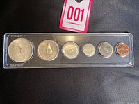 Full set of 1967 Canadian Centennial coins housed in clear protective plastic case, six coins in a row from largest to smallest.