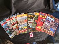 Group of eight vintage Street Rodder and Hot Rodding magazines arranged in a fan shape.