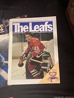 Cover of 'The Leafs' hockey program showing hockey player in red jersey with number 20