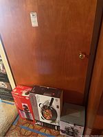 Photo of boxed Denmark Jumbo Cooker, GE single serve blender, and 16 jar orbit spice rack together