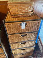 Front view of rattan chest with five woven drawers and sewing basket on top
