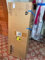 Cardboard shipping box with blue Total Gym logo on front