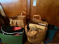 Two paper bags filled with shoes and shoe boxes. One bag includes a visible Franco Sarto shoe box, the other appears to hold multiple pairs of shoes.