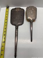 Full view of hand mirror and brush with measuring tape showing length about 14 inches