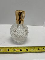 Side view of the round patterned glass diffuser lamp with measuring tape showing approximately 4-5 inches height.
