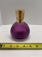 Full front view of purple ribbed diffuser lamp with measuring tape for scale