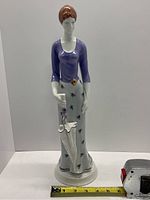 Front view of the large Hollohaza figurine showing the full figure and umbrella.