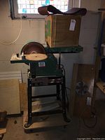Full view of belt/disc sander on stand with box of belts on top