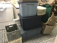 Photo shows stacked plastic storage bins with lids and small plastic drawer, plus two milk crates at bottom center and right.