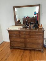 Full view of wooden vintage dresser with mirror above, showing overall dimensions and condition.