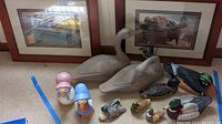 Photo of entire lot with wooden duck statues, ceramic figurines, smaller wooden ducks, and framed duck and fruit wall art.