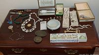 Overview on wooden surface: jewelry, glass box, trinket bowl, soap box