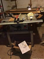 Ryobi table saw with metal base, measuring ruler along front