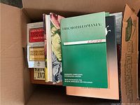 Box containing miscellaneous books including topic titles on insects and mental health.