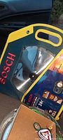 Image showing the saw blade inside the custom carry case with handle, branded Bosch.