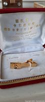 Gold-tone clip-on pin inside a red velvet presentation case with white satin interior. The case lid shows gold embossed Chinese text and English text indicating it was presented by General Yu Hao-Chang, Commander in Chief of Nationalist Chinese Army.
