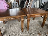 Two square wooden side tables placed side by side showing top and legs.