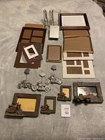 Overview of various picture frames and metal Americana decorative frames with motorcycles and trucks, assorted sizes and styles.