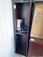 Full view of the tall wooden console hutch with shelving, showing the interior and exterior condition and some stored items inside