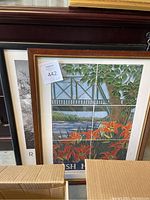 Framed tile artwork poster signed by Rush Holt and Katherine Hach showing a river, bridge, tree, and orange flowers.