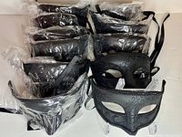 Eleven black half face masquerade masks packaged together, with one mask out of packaging showing matte and glitter design
