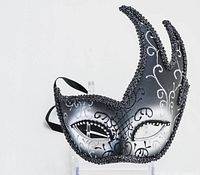 Close-up of the fancy Venetian-style black and silver masquerade mask showing detailed bead trim and silver swirl patterns.