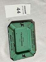 Top angled view showing black horse logo at corners and 'Black Horse Canada's Finest Ale' text on sides with wear marks.