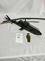 Full side view of GI JOE Dragonfly helicopter with Wild Bill figure beside it on white cloth background.