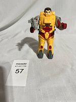 Front view of Landmine Pretender Transformer figure in outer shell armor holding a grey weapon.