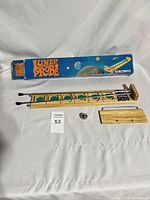 Full view of Lunar Probe game track laid out with steel ball, wooden base piece, and box in background