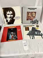 Shows four vintage LP records in their covers: Gordon Lightfoot 'Summertime Dream', John Coltrane 'Giant Steps', Bob Marley and The Wailers 'Sound Revolution', Sergei Rachmaninoff 'Concert Etudes'. Untested condition.