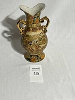 Full view of the vase showing its shape, handles, and detailed hand-painted decorations