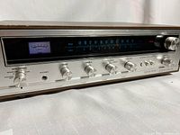 Front angled view of the Pioneer Model 300 stereo receiver showing the power and speaker controls, headphone jack, bass, treble, and illuminated tuner display.