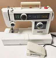 Full view of Omega #1260-d white sewing machine with foot pedal in front.