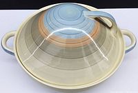 Top view of Susie Cooper ‘Kestrel’ covered vegetable serving bowl showing multi-colored concentric rings and lid handle.