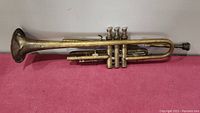 Side view of entire trumpet showing length and valve arrangement