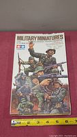 Photo of the sealed box of Tamiya 1/35 Military Miniatures German Assault Troops set showing detailed box art and scale.