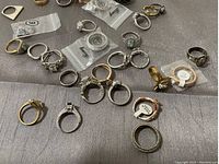 Assorted rings scattered on gray cloth background