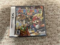 Front view of Mario Party DS game case showing colorful cover art and ESRB rating
