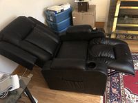 Side view of chair fully reclined showing extended footrest and one cup holder