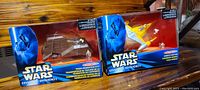 Both boxed Star Wars Episode I toys side by side showing front packaging.