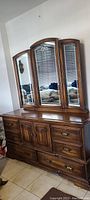 Full front view of the dresser with tri-fold mirror showing overall condition and design
