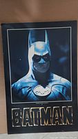 Photo of the vintage Batman poster showing the upper body of Batman in costume and the text 'BATMAN' below.