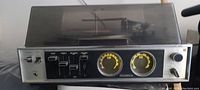 Front view of the vintage Panasonic receiver and turntable with the dust cover down, showcasing the controls and knobs on the front panel.