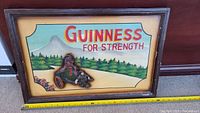 Front view of the wooden framed painting showing Guinness advertisement with 3D horse and cart artwork.