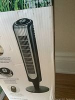 Boxed Bionaire tower fan showing fan image and control panel illustrations on packaging
