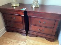 Pair of matching modern dark wood night stands with two drawers each, showing overall condition and design.
